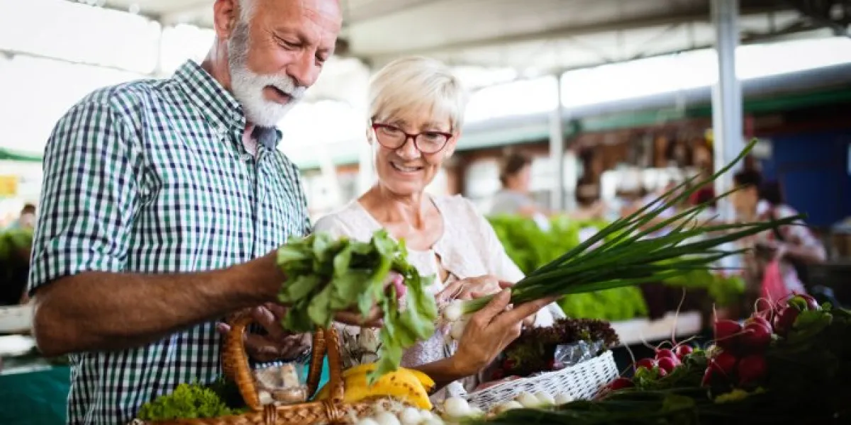 mature couple shopping vegetables and fruits on the market healthy diet