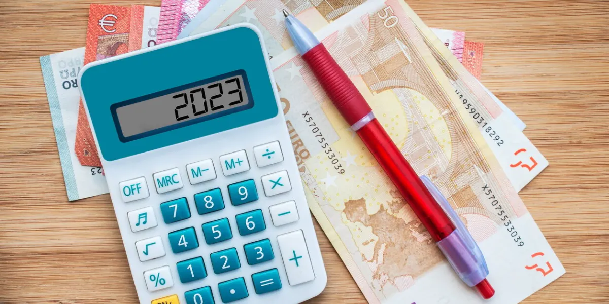 2023 numbers on a calculator and euros banknotes, new year finance, money inflation and budget concept