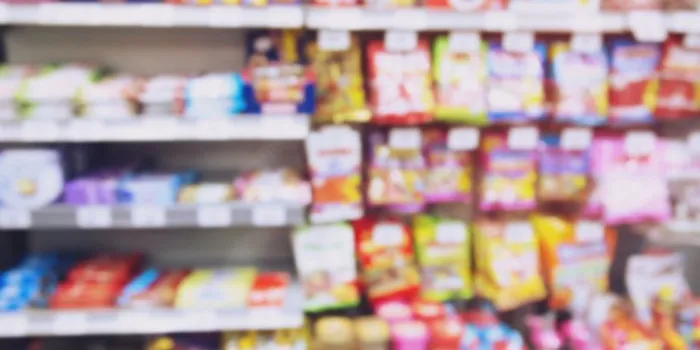 blur photo background of snacks and consumer product colorful in supermarket shop shelf mini-mart shopping convenience stores are a new alternative for the urban people concept
