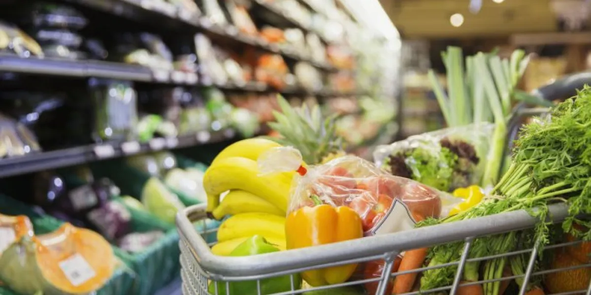 close up of full shopping cart in grocery store