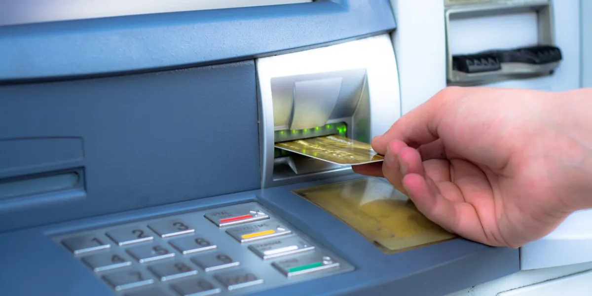 hand inserting atm credit card