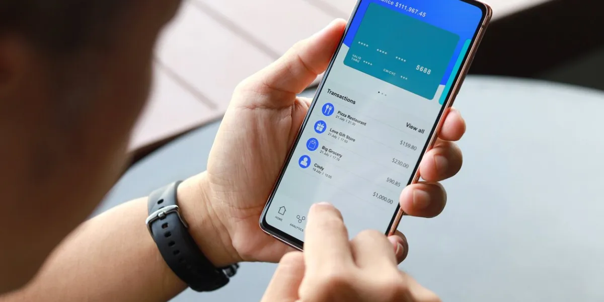 cropped image of asian man checking bank account and spending using his mobile device convenience and easy banking with technology