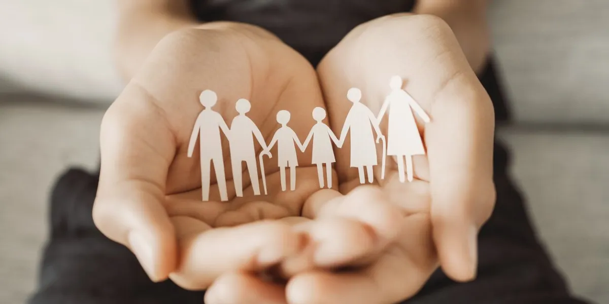 hands holding multi generation family paper, family wellness, health insurance concept