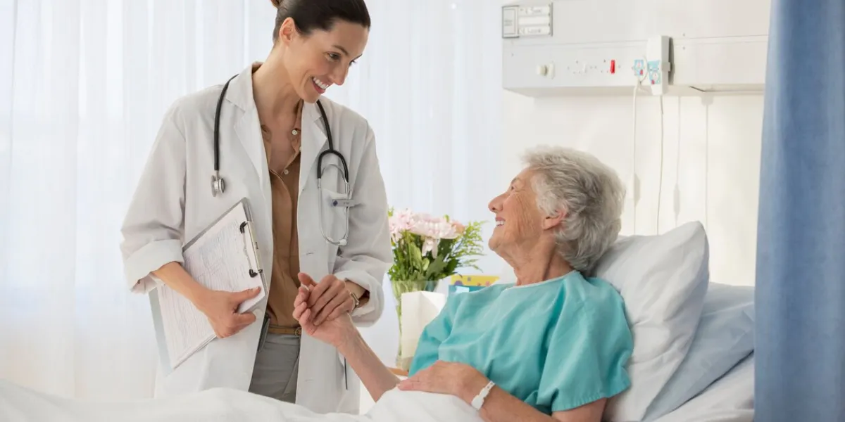 doctor and senior patient talking in hospital room