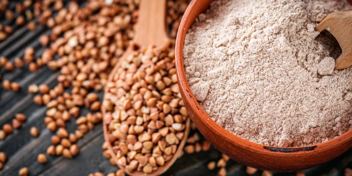 fresh natural buckwheat flour on a dark wooden rustic background culinary concept