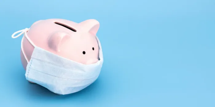 pink piggy bank stands on a blue medical background in a medical mask, on the right there is an empty space for the text chinese coronavirus, 2019-ncov