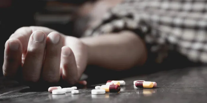 close up of overdose pills and addict