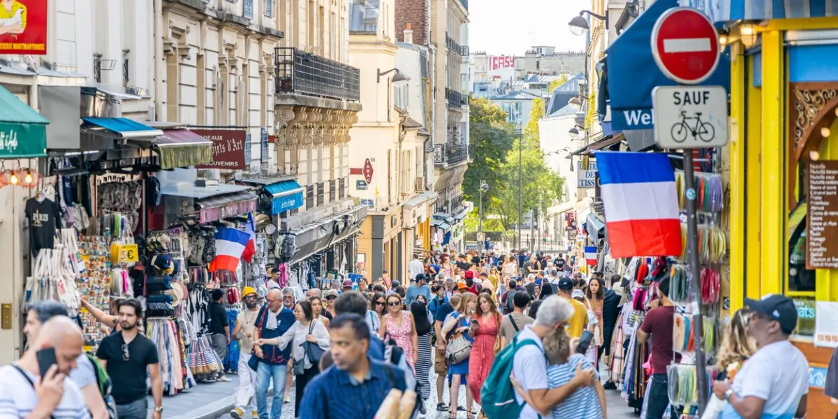 paris, france - september 10, 2023   crowd of tourists walking in a shopping street of montmartre district in paris france