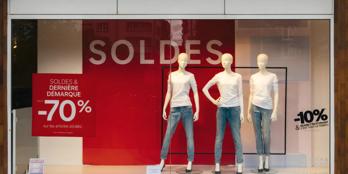paris, france - jul 27, 2017  soldes inscription with mannequins wearing elegant clothes and special last minutes 70 percent discount sales for fashion products on central avenue