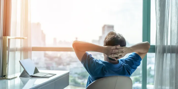 life-work balance and city living lifestyle concept of business man relaxing, take it easy in office or hotel room resting with thoughtful mind thinking of life quality looking forward to cityscape