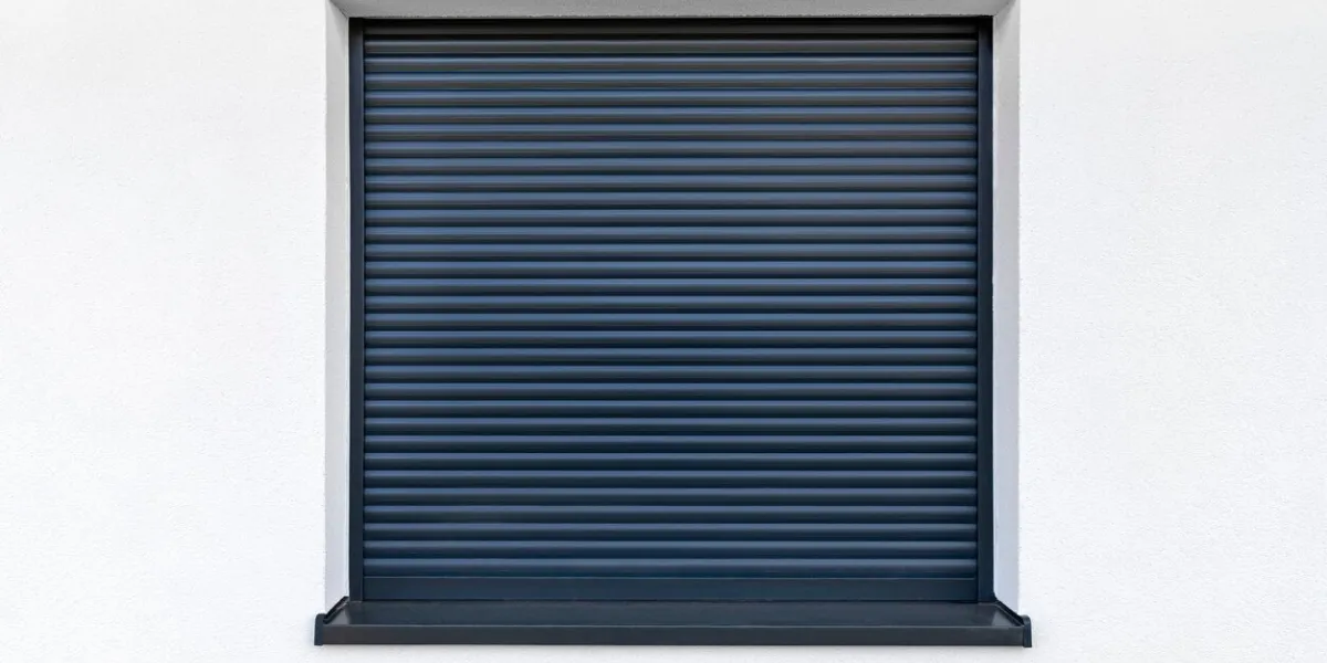 large window in anthracite color with fully covered external blinds, view from the outside of the building