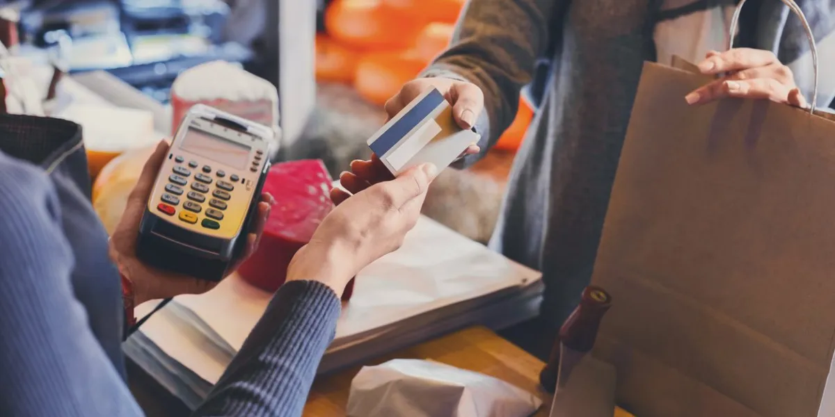 retail, credit card payment service customer paying for order of cheese in grocery shop