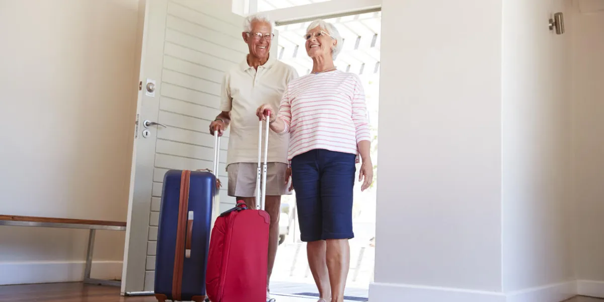 senior couple arriving at summer vacation rental