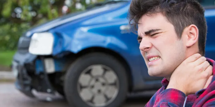 male motorist suffering from whiplash after car accident