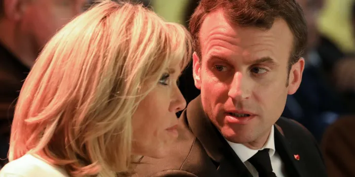 french president emmanuel macron (r) speaks to his wife brigitte macron during a meeting of the bishops' conference of france (cef) at college des bernardins in paris, on april 9, 2018   afp photo   pool   ludovic marin