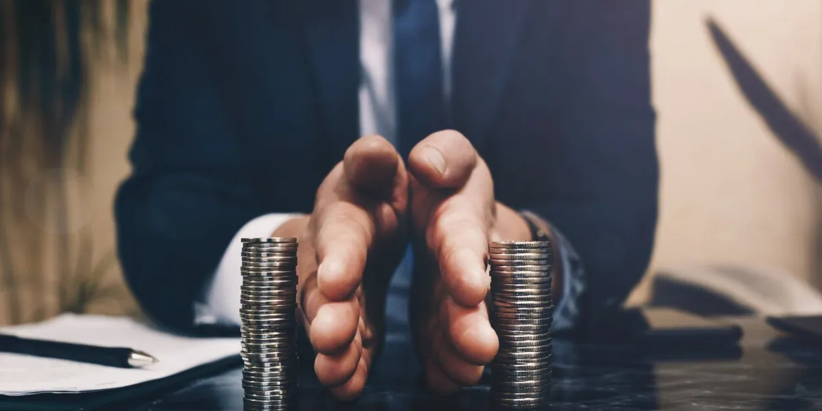 businessman separates stack coins concept of saving and investing property division divorce and legal services