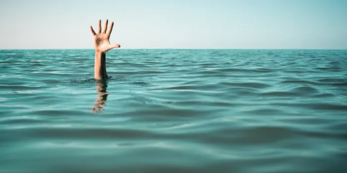 hand in sea water asking for help failure and rescue