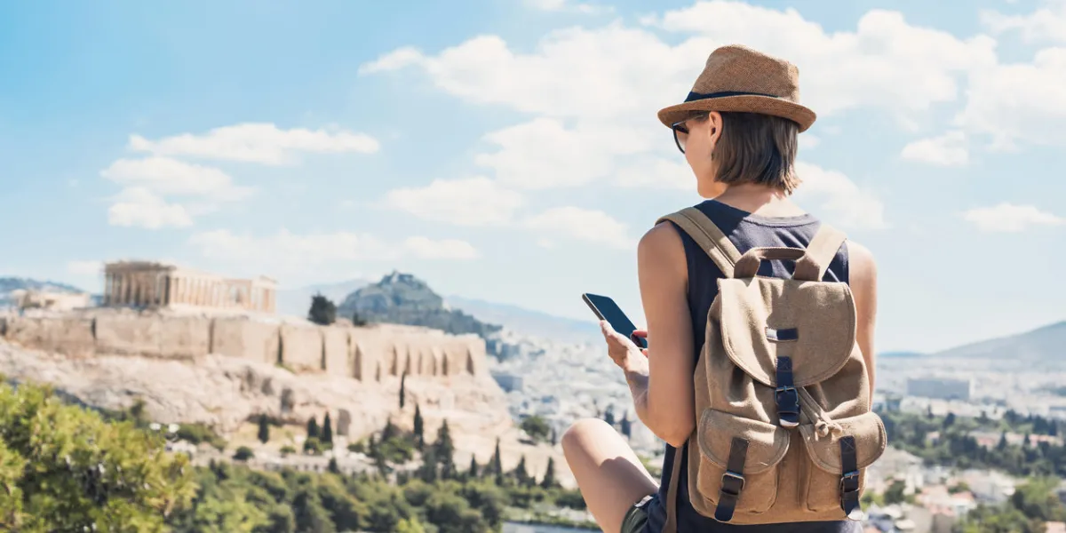 young woman traveler using mobile phone outdoor