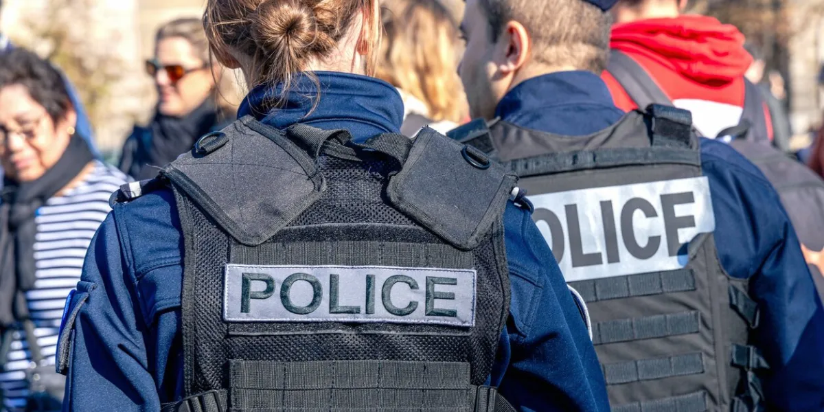 two policemen, a man and a woman, wearing bulletproof vest with the word police on them paris, france - november 1