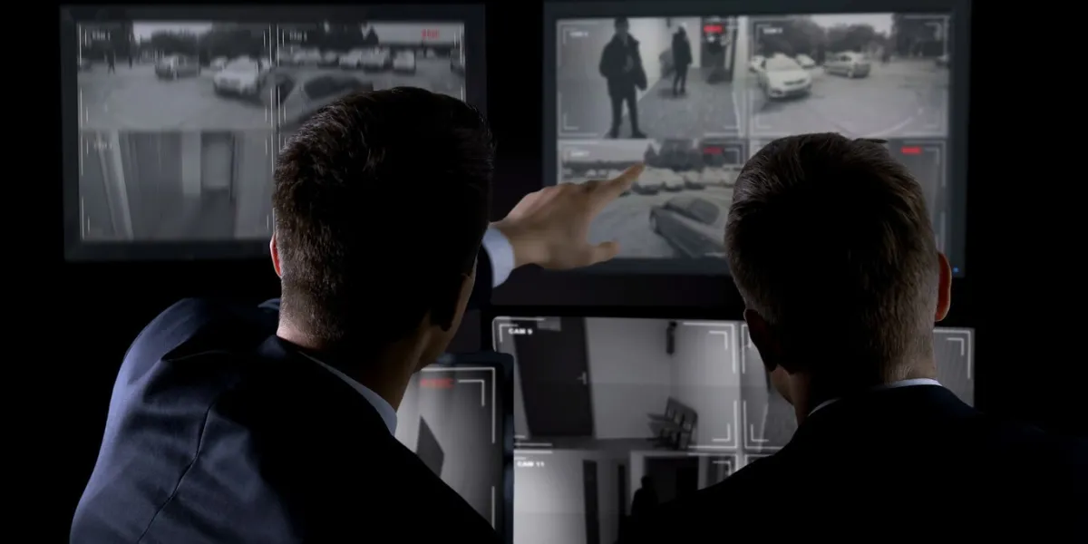 private agents monitoring cctv footage, searching for criminal, discussion