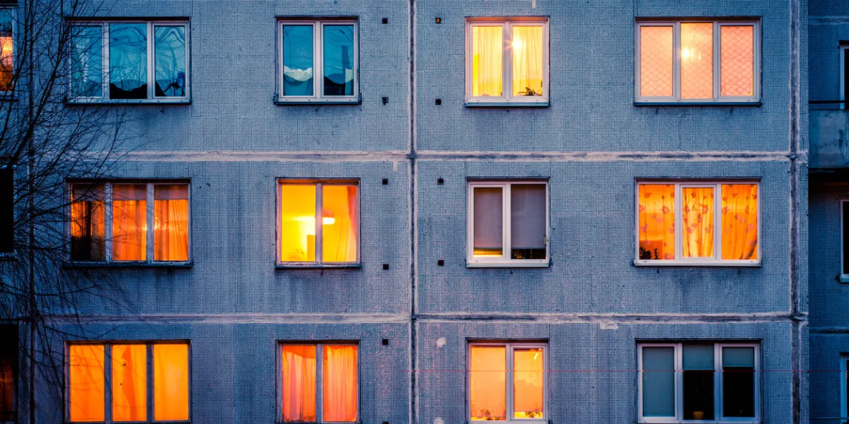 wall with iluminated windows detail of soviet era block apartment building