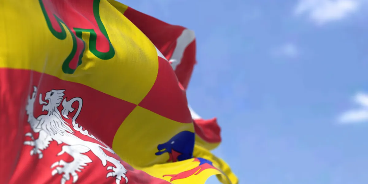 the flag of auvergne-rhone-alps flying on a clear day auvergne-rhone-alpes is one of the regions of france