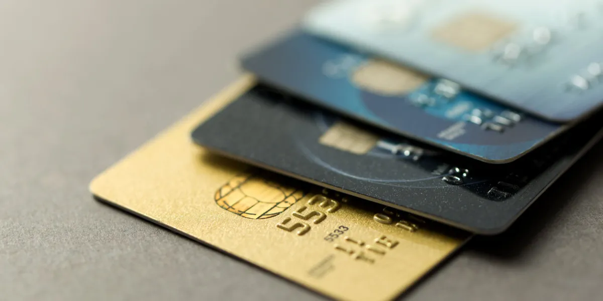 close up of credit cards over grey background