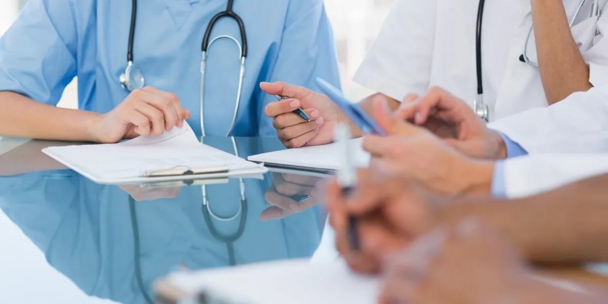 mid section group of young doctors in a meeting at hospital