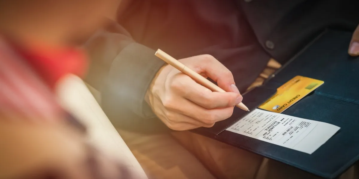credit card payment bill and slip with hand holding pen ready to sign to make payment at shop