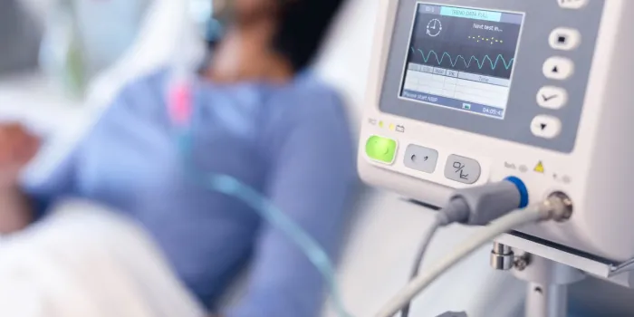 ventilator monitor and african american female patient in hospital bed with oxygen ventilator medicine, health and healthcare services during coronavirus covid 19 pandemic