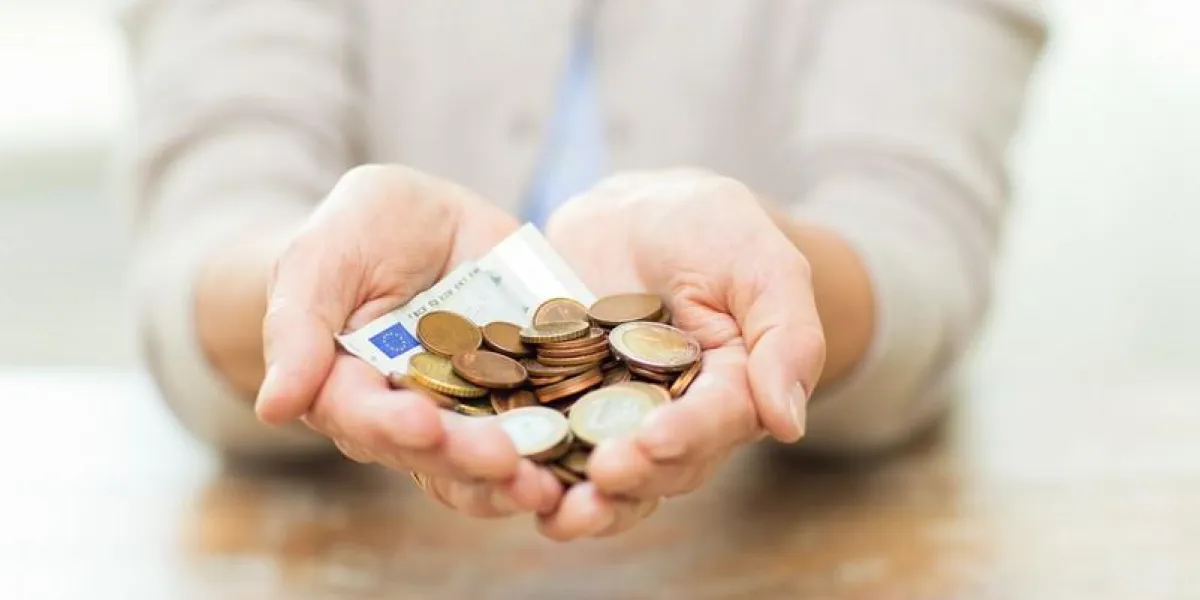 savings, money, annuity insurance, retirement and people concept - close up of senior woman hands holding money jar