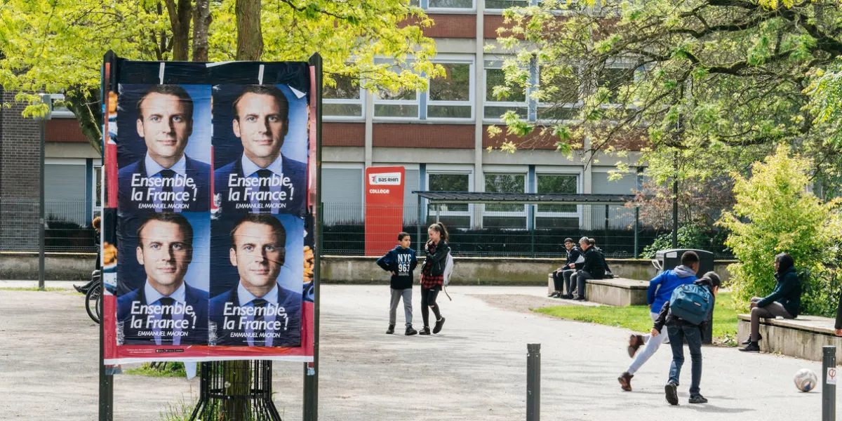 strasbourg, france - may 5, 2018  street photography of emmanuel macron, candidate to the presidency of france poster on a dedicated campaign agitation area in front of french school lyceum