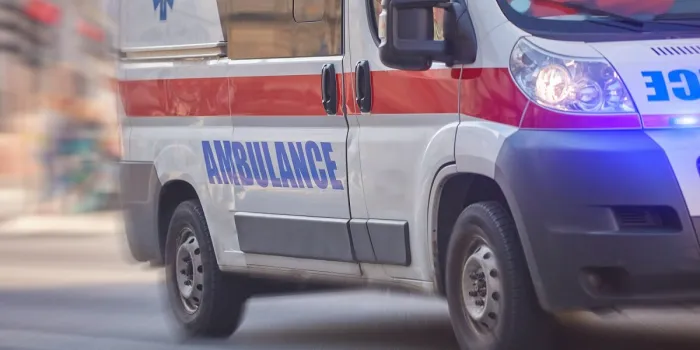 paramedic 911 ambulance car running fast through the big city