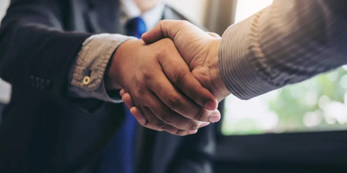 two business men shaking hands during a meeting to sign agreement and become a business partner, enterprises, companies, confident, success dealing, contract between their firms