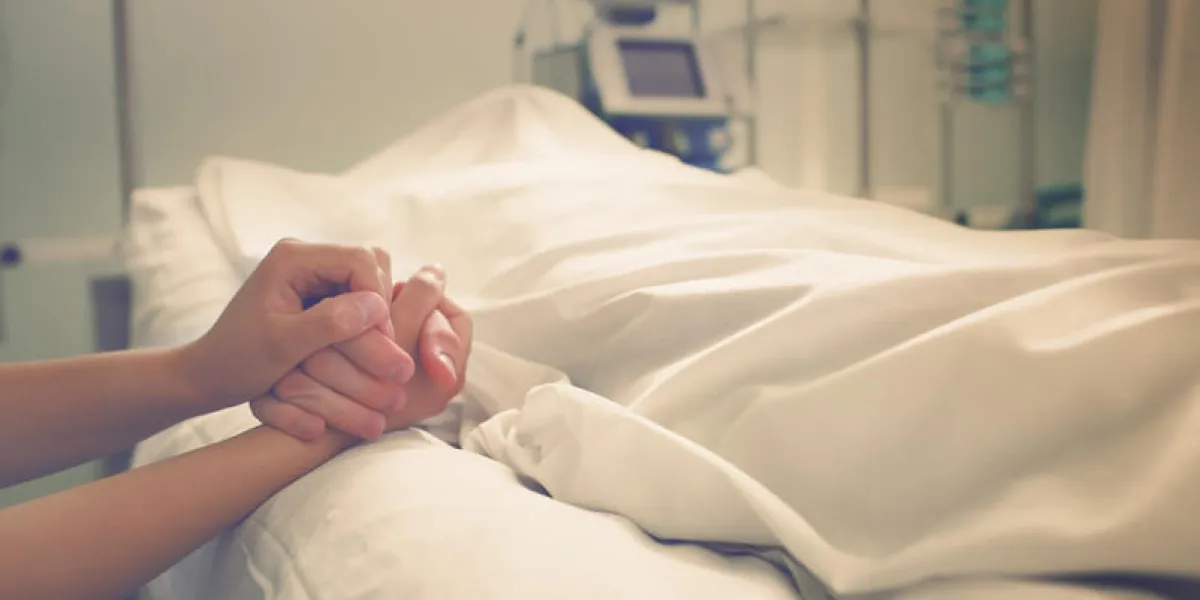 woman mourns her husband, who died in a hospital