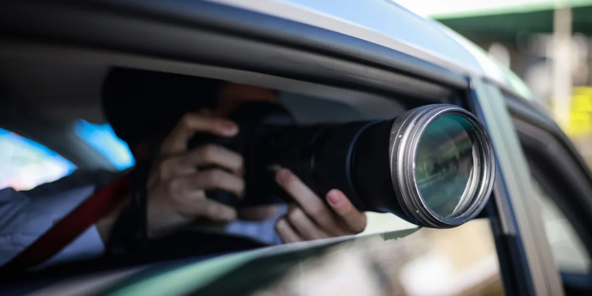 a man taking a picture from inside the car