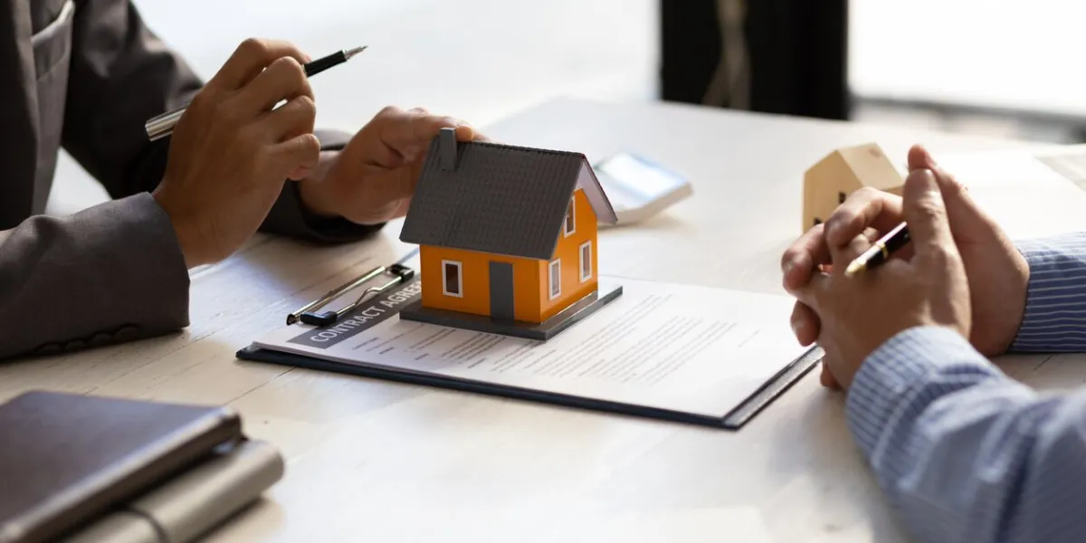 real estate agent discuss about the terms of the home purchase agreement and asked the customer to sign the documents to make the contract legally, home sales, lease, mortgage and home insurance
