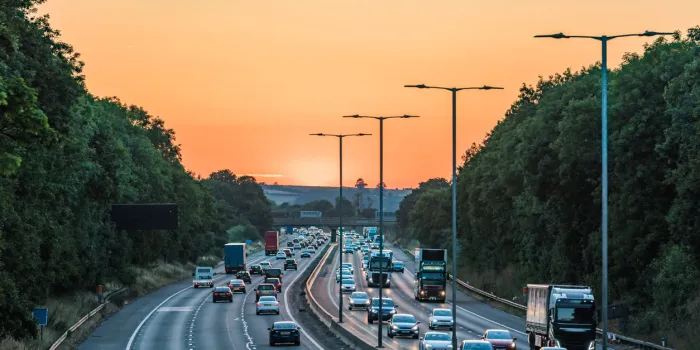 sunset view of busy uk motorway traffic in england