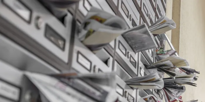 modern metal mail boxes, overfull of leaflets ideal for concepts