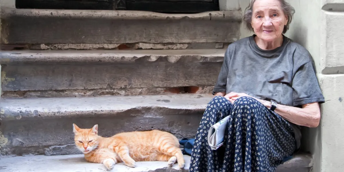old woman in poverty sitting on street