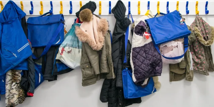 rack of coats on pegs in school