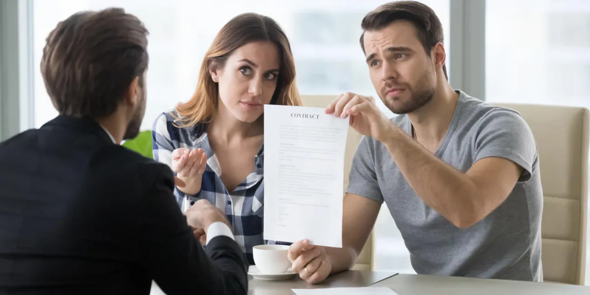 young skeptic couple meet lawyer dissatisfied with terms of suspicious contract, refuse to sign family buying renting house, apartment, real estate, taking bank loan displeased customer ask question