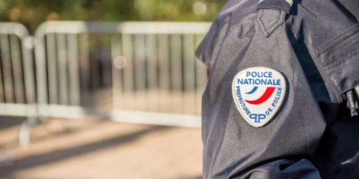 paris, france - october 28, 2012  close-up on a french policeman ensuring the safety of the citizens in the street, close view on his badge