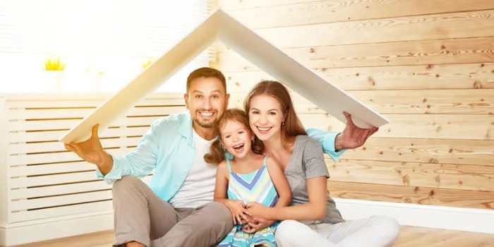 concept housing a young family mother father and child in new house with a roof