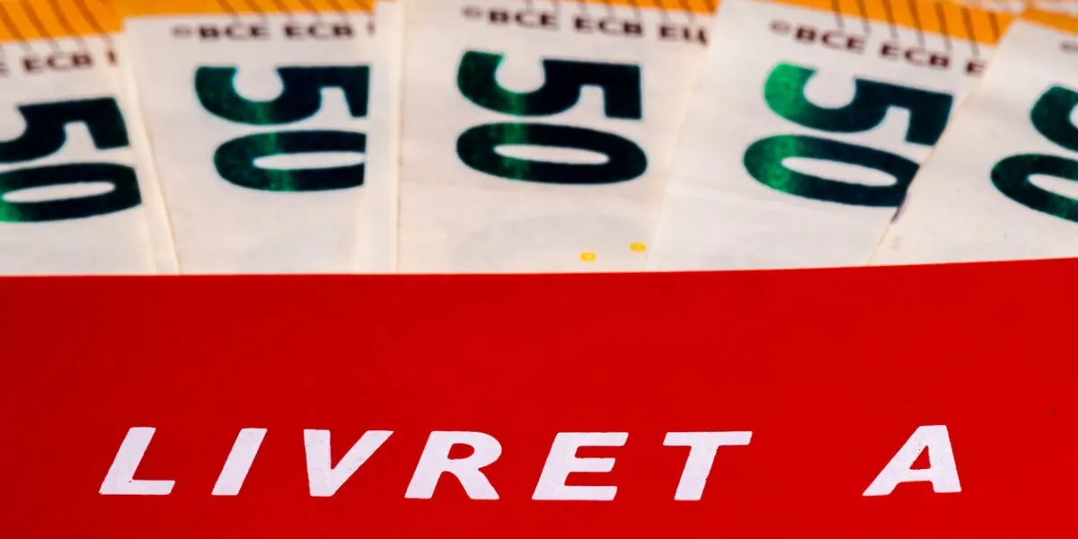 close-up of a livret a with several 50 euro notes the livret a is a regulated french savings account with interest rate and deposit limit defined by the government