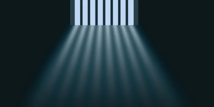 concept of prison and deprivation of liberty with daylight illuminating the inside of a cell through the bars of the window