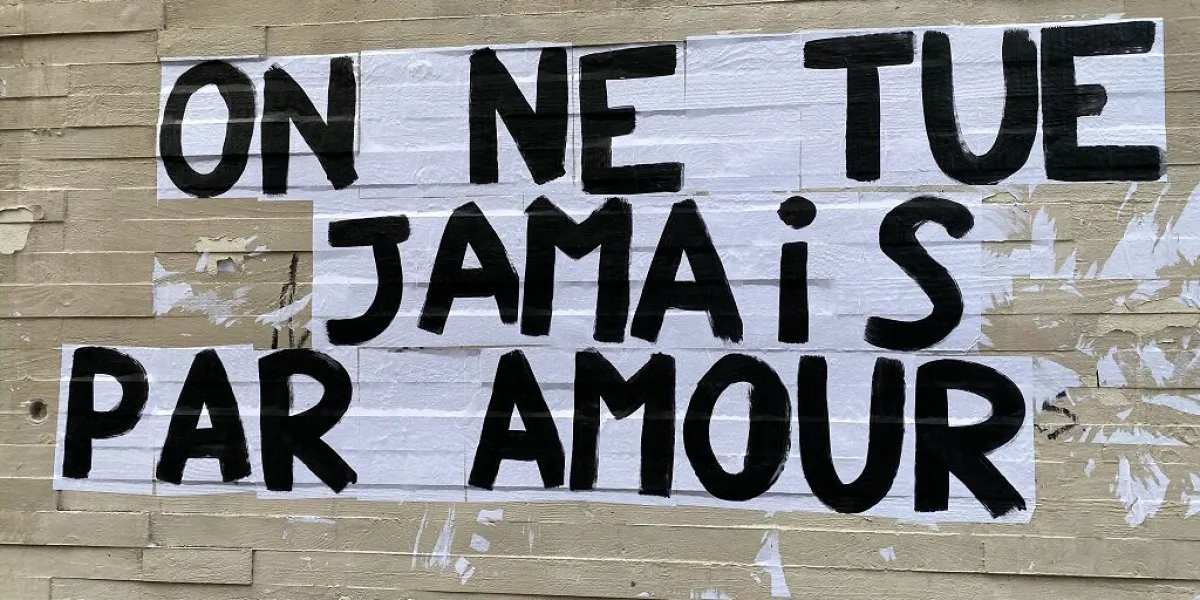 protest poster against domestic violence and femicide stuck on a wall in paris france, saying we never kill for love