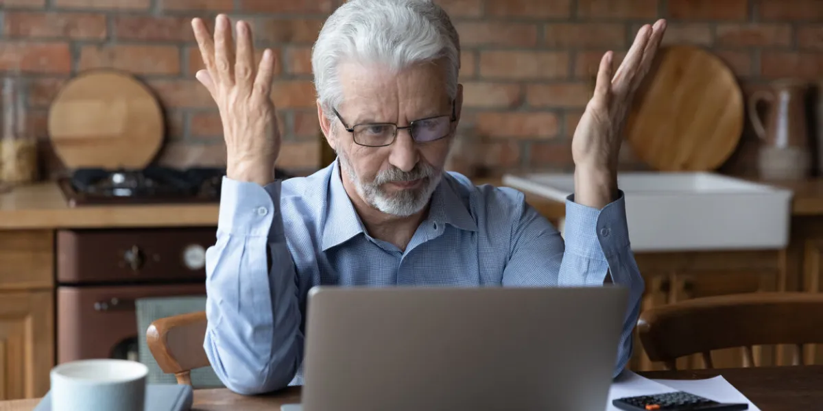 annoyed worried aged man pensioner sit by laptop unable to make utility bill loan payment online has question how to use app need help stressed old grandpa confused with unexpected debt on pc screen