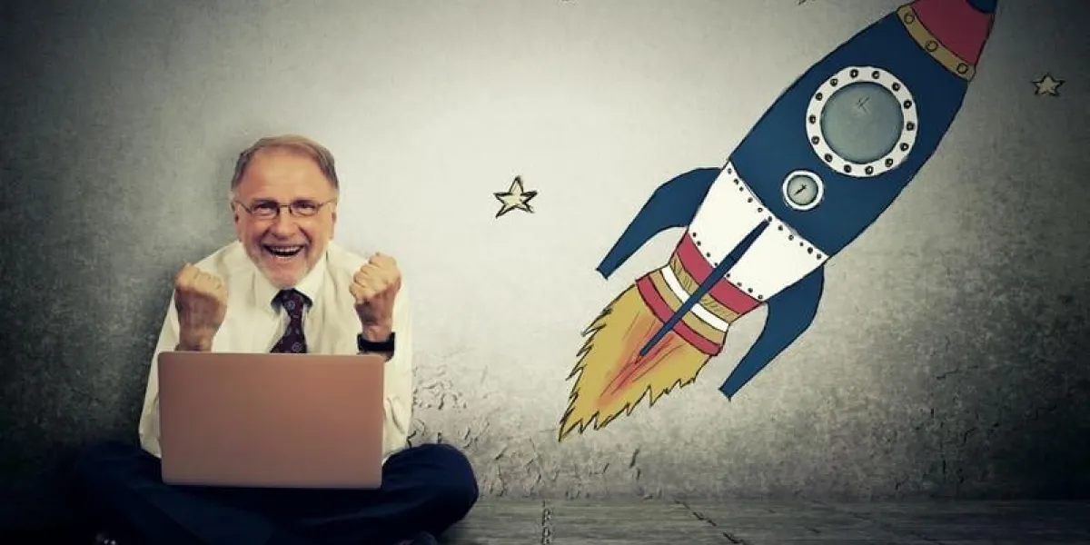 excited senior man with high risky goals targets working on laptop computer on a starry wall background successful adventure concept