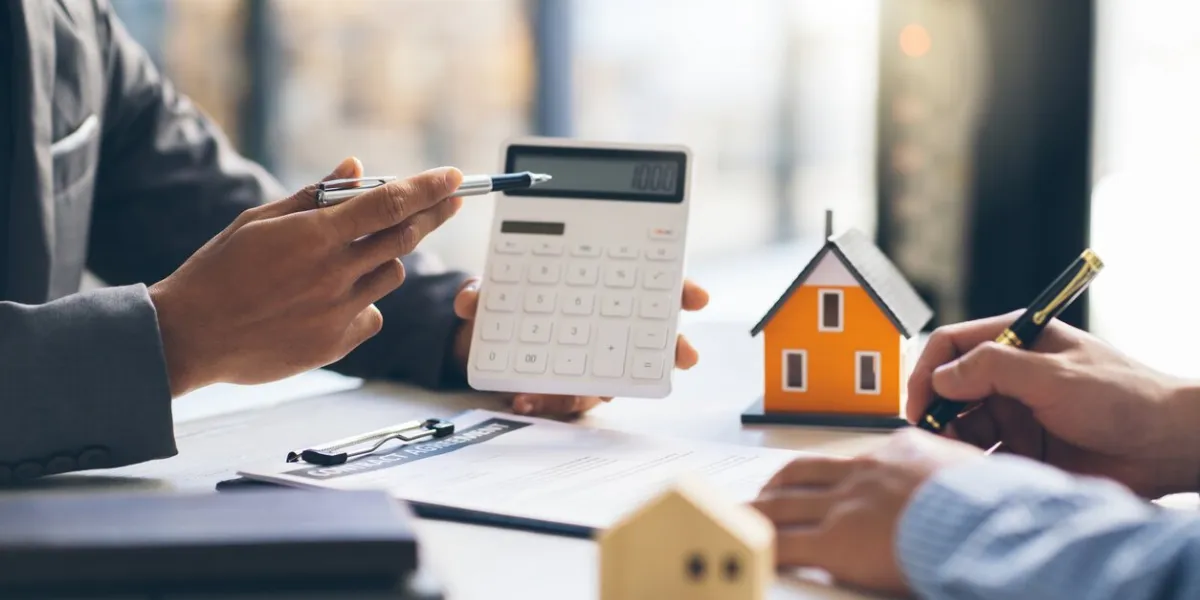 house model with agent and customer discussing for contract to buy, get insurance or loan real estate or property